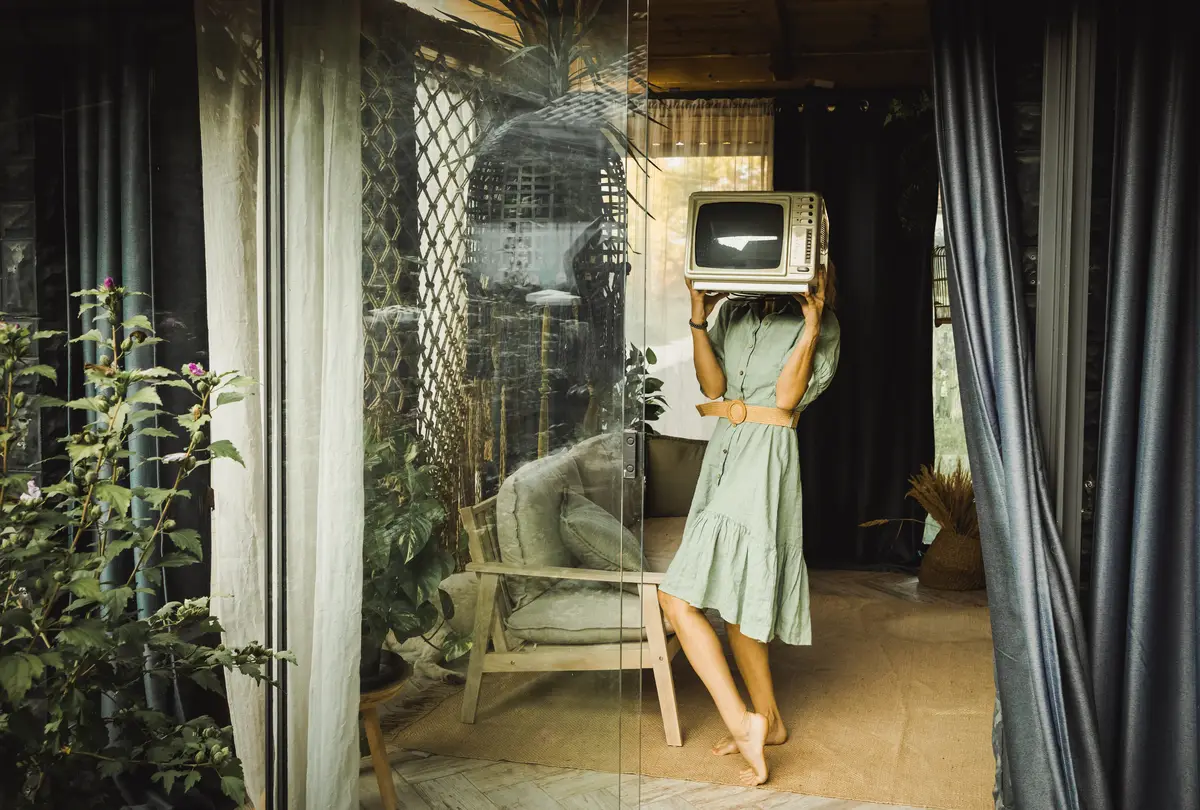 A vintage television set glowing in a dim room